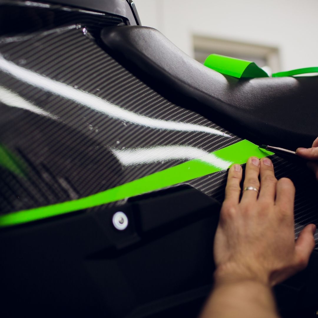 Hands applying a custom vehicle wrap