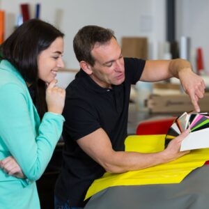 A man showing someone different wrapping colors.